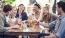 a group of people sitting around a table with drinks