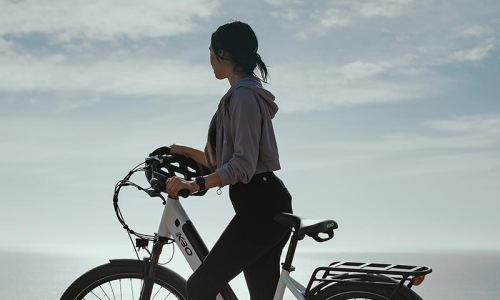 a man standing next to a bicycle
