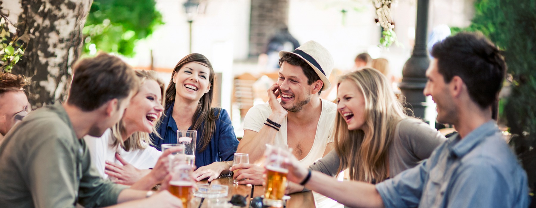 a group of people sitting around a table with drinks